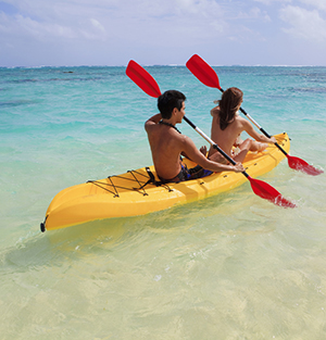 Couple kayaking in Caribbean Sea, Antigua